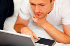 man reading on laptop